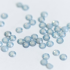 Rozsypane jasnoniebieskie opalowe kryształki Pastel Blue na jasnym tle